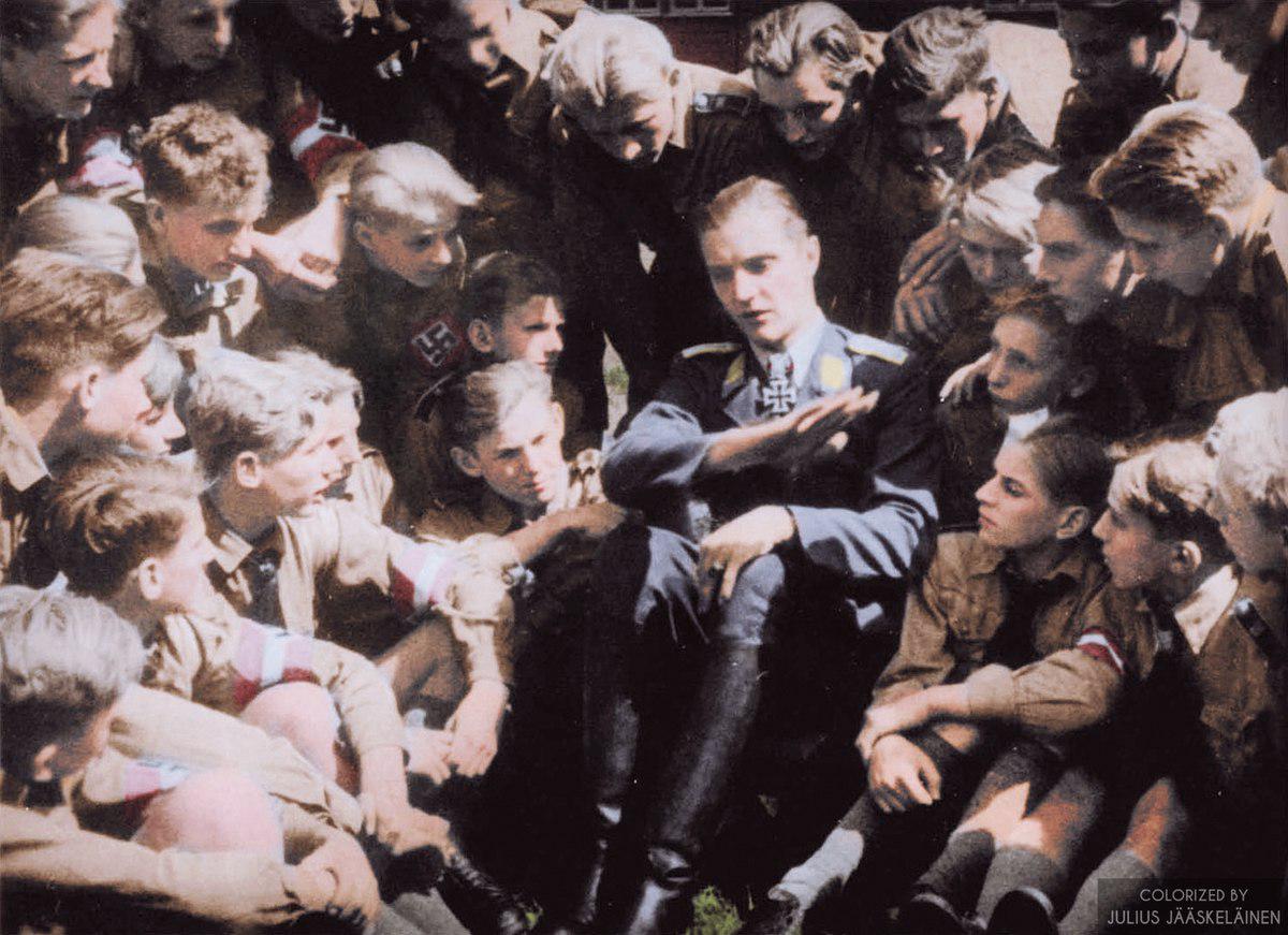 Colorized] Luftwaffe Ace Hans Joachim Marseille telling a group of